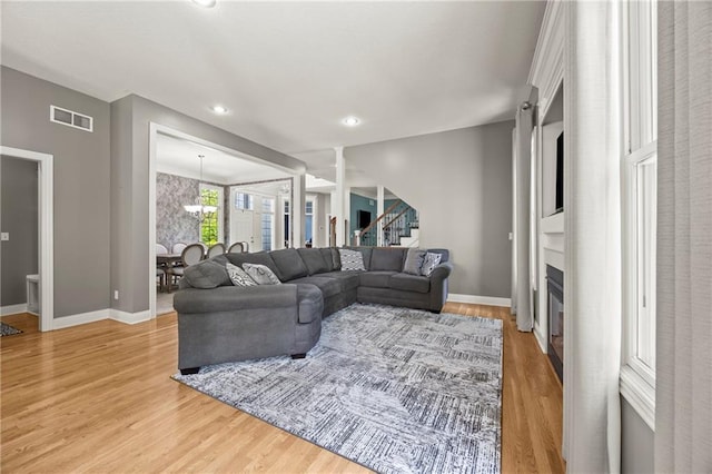 14692 S Garnett St, Olathe, KS 66062 - living area with a large fireplace, light wood-type flooring, stairway, and recessed lighting