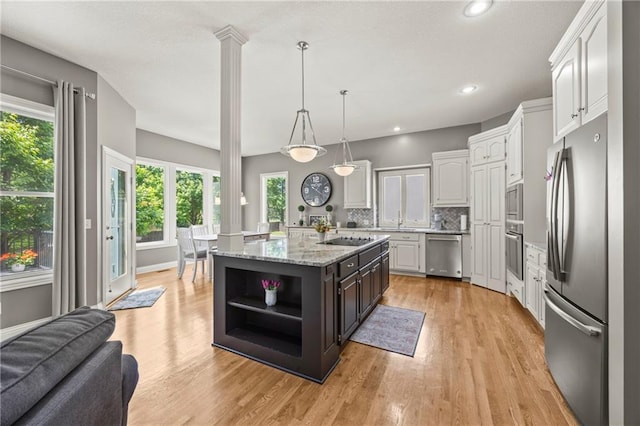 14692 S Garnett St, Olathe, KS 66062 - kitchen featuring appliances with stainless steel finishes, open shelves, white cabinets, a center island with sink, and light wood finished floors