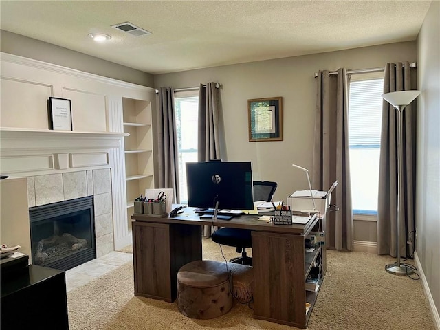 14692 S Garnett St, Olathe, KS 66062 - office area featuring light colored carpet, a textured ceiling, and a tiled fireplace