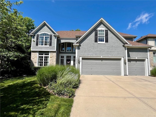 14692 S Garnett St, Olathe, KS 66062 - view of front of home with concrete driveway, a front lawn, stucco siding, and stone siding