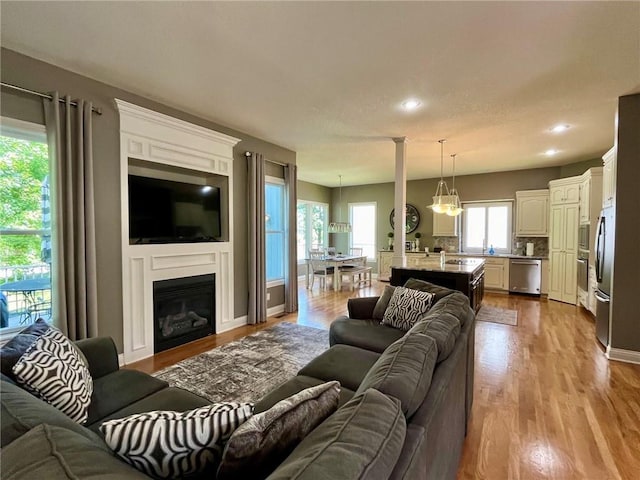 14692 S Garnett St, Olathe, KS 66062 - living area featuring wood finished floors, recessed lighting, and a glass covered fireplace