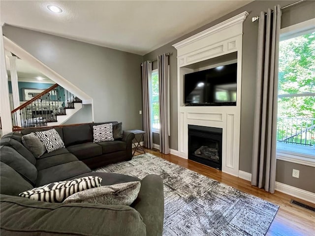 14692 S Garnett St, Olathe, KS 66062 - living area with plenty of natural light, wood finished floors, and stairs
