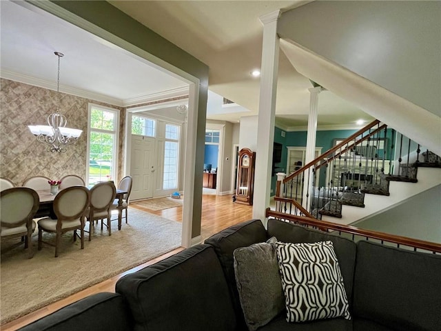 14692 S Garnett St, Olathe, KS 66062 - living area with crown molding, a chandelier, stairway, wood finished floors, and wallpapered walls