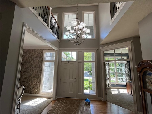 14692 S Garnett St, Olathe, KS 66062 - foyer entrance featuring plenty of natural light, a chandelier, wood finished floors, and a high ceiling