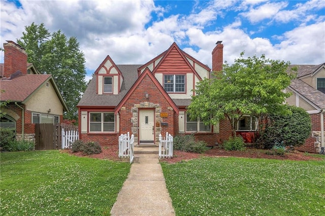 722 E Meyer Blvd, Kansas City, MO 64131 - tudor-style house featuring brick siding, a chimney, and roof with shingles