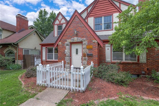 722 E Meyer Blvd, Kansas City, MO 64131 - tudor home with brick siding, stone siding, and roof with shingles