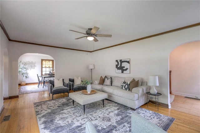 722 E Meyer Blvd, Kansas City, MO 64131 - living area with arched walkways, ceiling fan, crown molding, and hardwood / wood-style floors