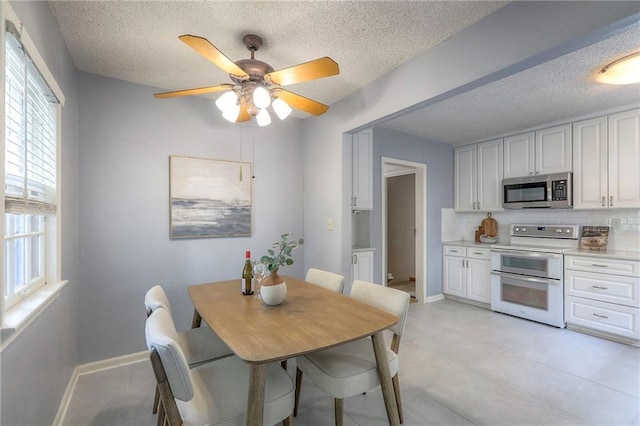 722 E Meyer Blvd, Kansas City, MO 64131 - dining area featuring ceiling fan and a textured ceiling