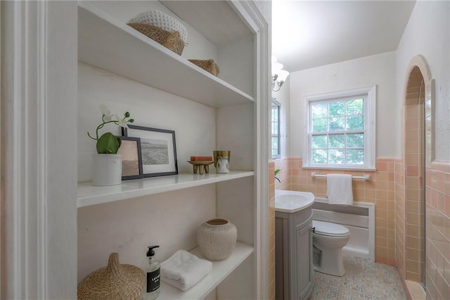 722 E Meyer Blvd, Kansas City, MO 64131 - bathroom with vanity, tile walls, and wainscoting