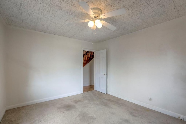 722 E Meyer Blvd, Kansas City, MO 64131 - carpeted spare room featuring baseboards and a ceiling fan