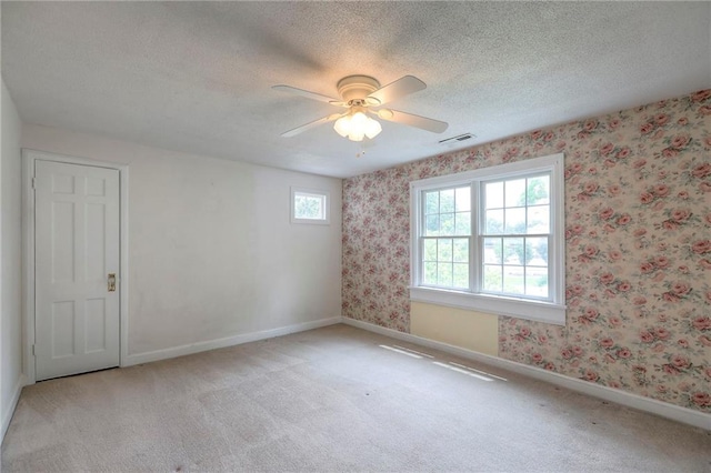 722 E Meyer Blvd, Kansas City, MO 64131 - unfurnished room featuring light colored carpet, ceiling fan, a textured ceiling, and wallpapered walls