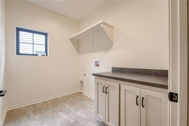 laundry area featuring baseboards, cabinet space, washer hookup, and electric dryer hookup
