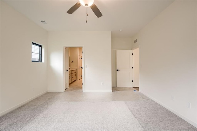 interior space with visible vents, baseboards, ceiling fan, and light carpet