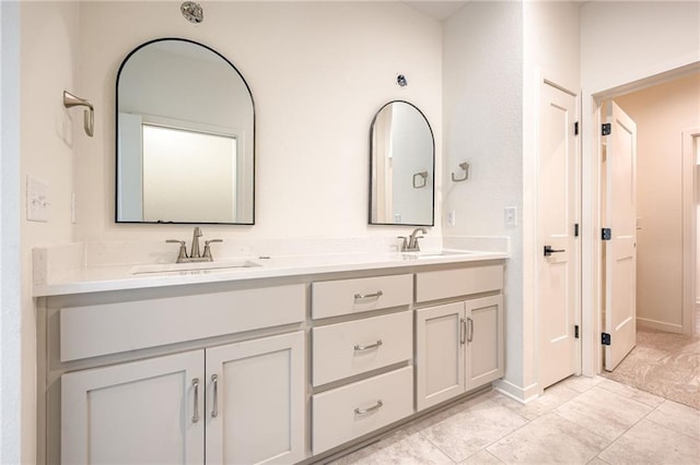full bathroom with double vanity and a sink