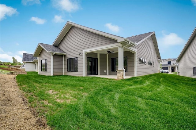 rear view of property with a patio area, a lawn, and ceiling fan