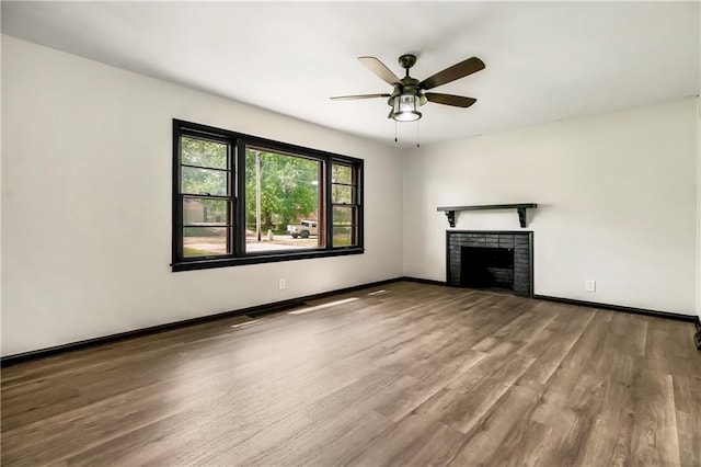 1910 Ottawa St, Leavenworth, KS 66048 - unfurnished living room featuring wood finished floors, a ceiling fan, baseboards, and a fireplace