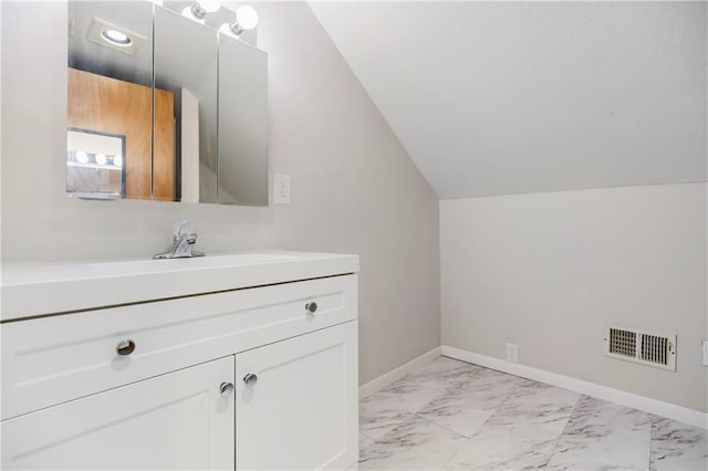 1910 Ottawa St, Leavenworth, KS 66048 - bathroom featuring lofted ceiling, marble look tile flooring, vanity, and baseboards