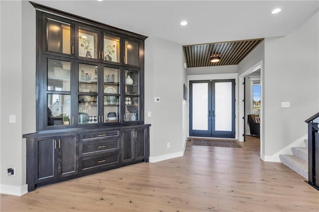 entryway with french doors, recessed lighting, stairway, light wood finished floors, and baseboards