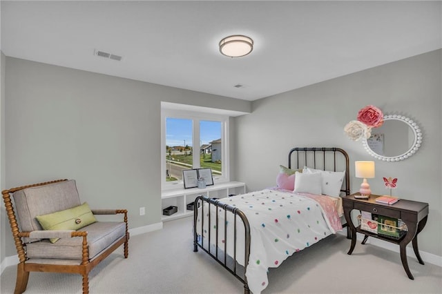 bedroom featuring visible vents, baseboards, and light carpet