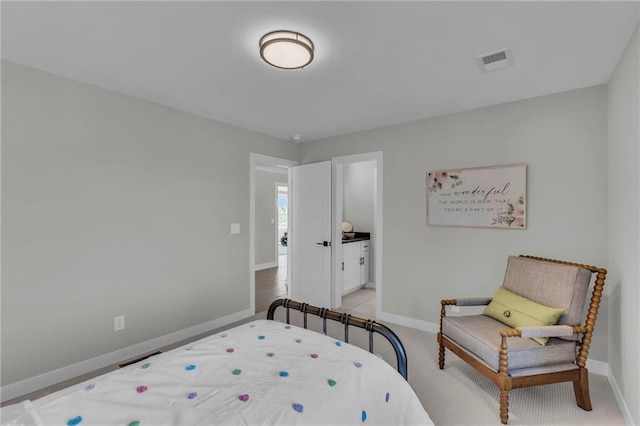 bedroom featuring baseboards, light carpet, and visible vents