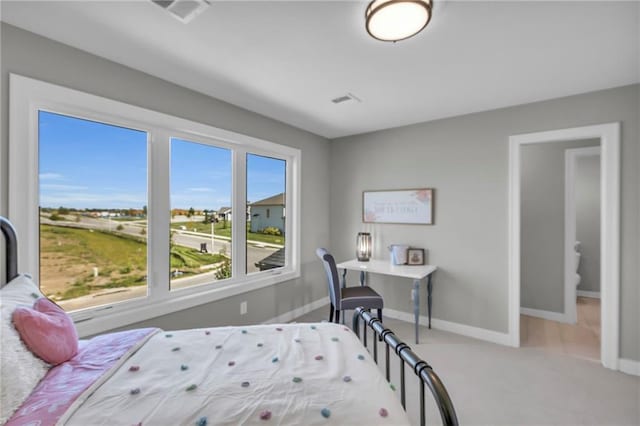 carpeted bedroom featuring visible vents and baseboards