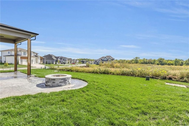 view of yard with a residential view, a patio, and a fire pit