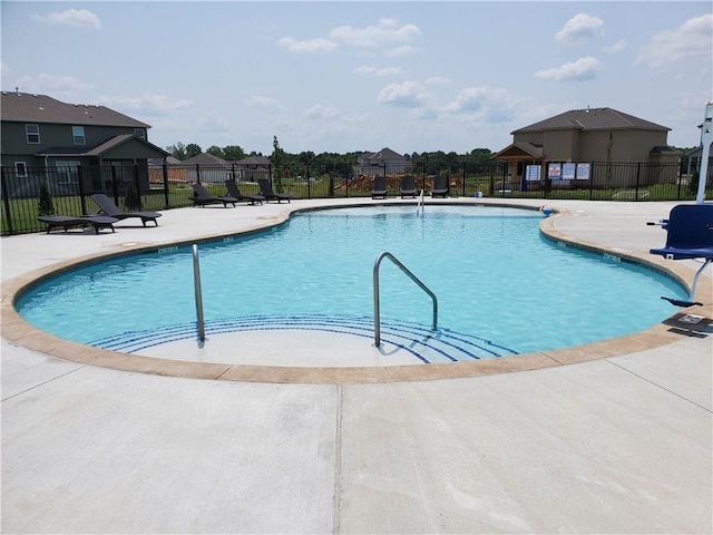 pool featuring fence and a patio