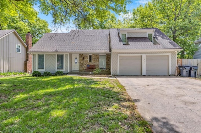 view of front of house featuring driveway, fence, a garage, a shingled roof, and a front lawn