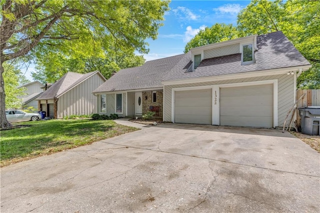 view of front of house with a garage, fence, a shingled roof, a front yard, and driveway