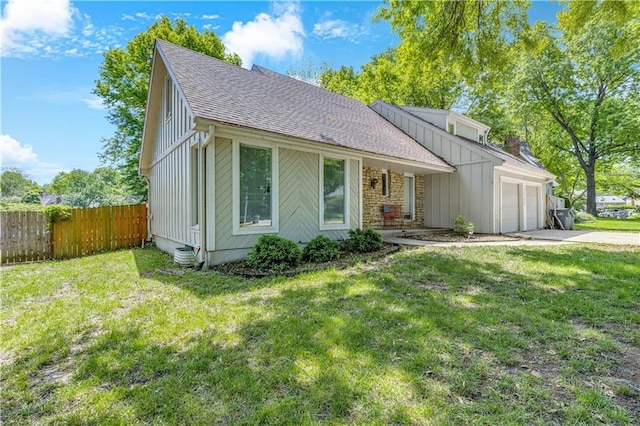 view of front facade with roof with shingles, fence, an attached garage, concrete driveway, and board and batten siding