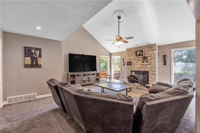 living area featuring carpet, visible vents, a ceiling fan, and a healthy amount of sunlight