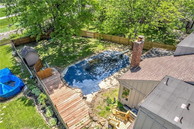 view of swimming pool featuring a lawn and a fenced backyard