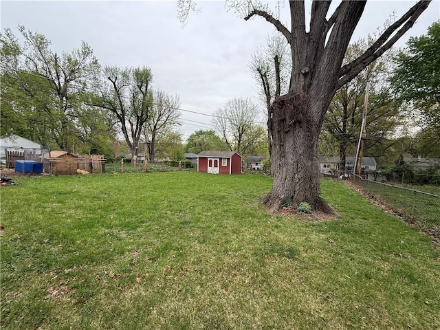 view of yard featuring a storage shed and an outdoor structure