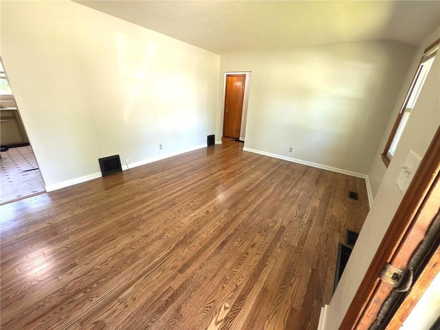 unfurnished room featuring dark wood finished floors and baseboards