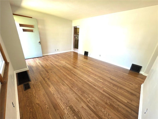 spare room with wood finished floors