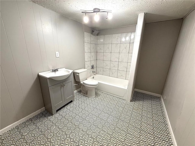 full bathroom with toilet, a textured ceiling, vanity, shower / bath combination, and baseboards