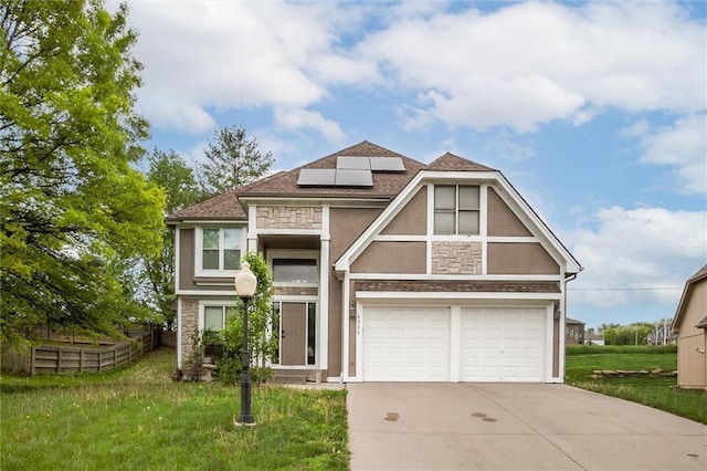 6700 N Charlston Dr, Kansas City, MO 64119 - tudor-style house with stucco siding, stone siding, concrete driveway, and roof mounted solar panels