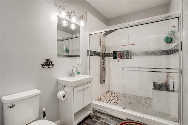 6700 N Charlston Dr, Kansas City, MO 64119 - bathroom featuring toilet, a shower stall, vanity, and wood finished floors