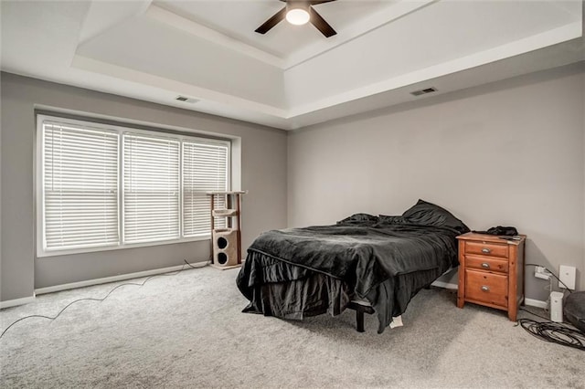 6700 N Charlston Dr, Kansas City, MO 64119 - carpeted bedroom with a tray ceiling, baseboards, and a ceiling fan