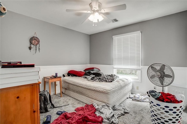 6700 N Charlston Dr, Kansas City, MO 64119 - carpeted bedroom with a wainscoted wall and a ceiling fan