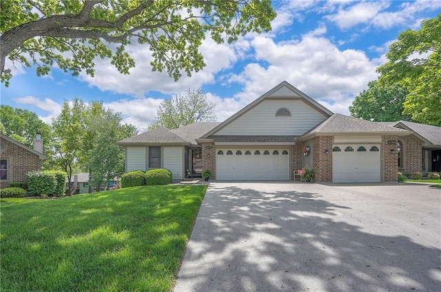 view of front of property featuring a garage, brick siding, a front lawn, driveway, and roof with shingles