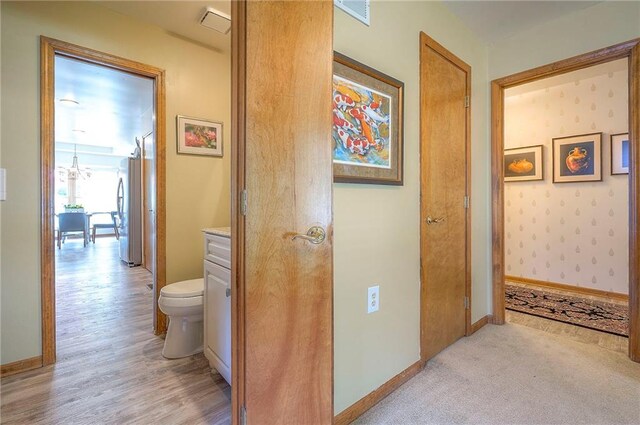 hallway with baseboards and light wood-style floors