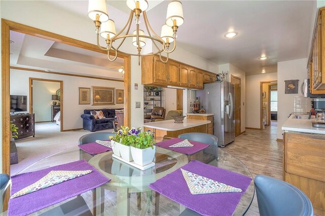 dining room with a chandelier and baseboards