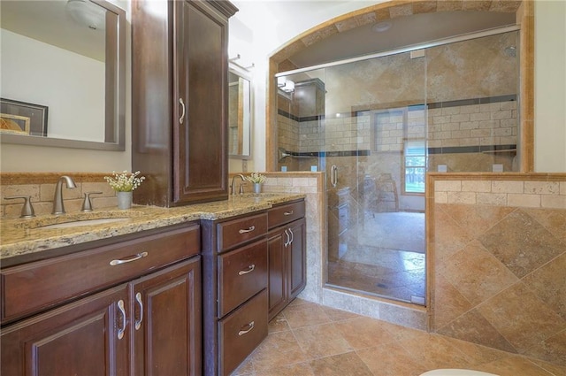 bathroom featuring vanity and a shower stall
