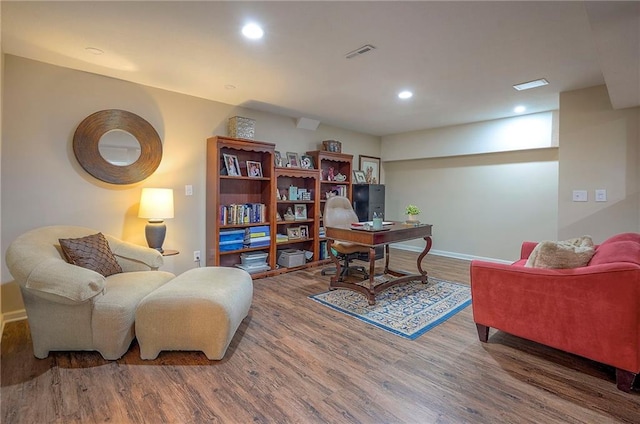 office featuring wood finished floors, baseboards, and recessed lighting