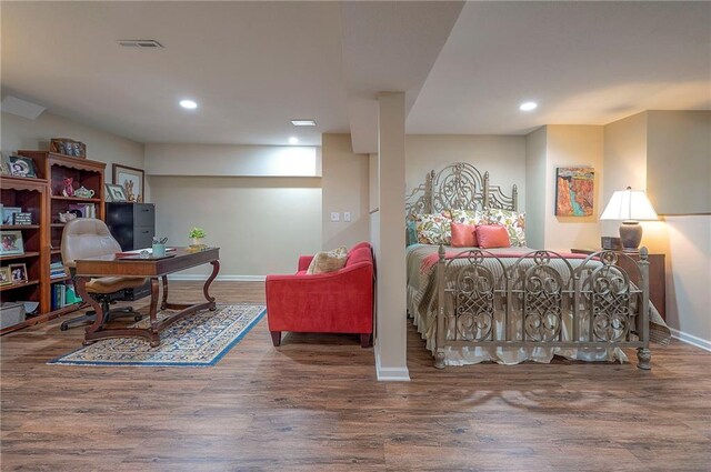 bedroom featuring baseboards, an office area, wood finished floors, and recessed lighting
