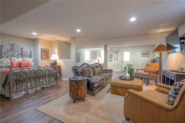 living area with wood finished floors, recessed lighting, and baseboards