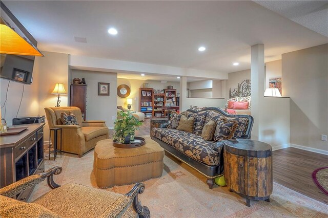 living room featuring wood finished floors, baseboards, and recessed lighting
