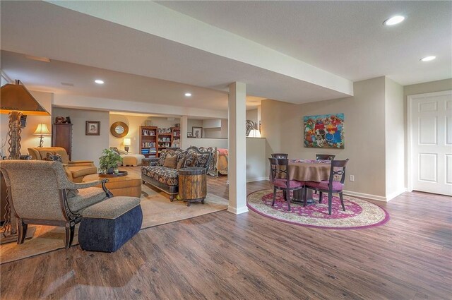 living room featuring wood finished floors, baseboards, and recessed lighting