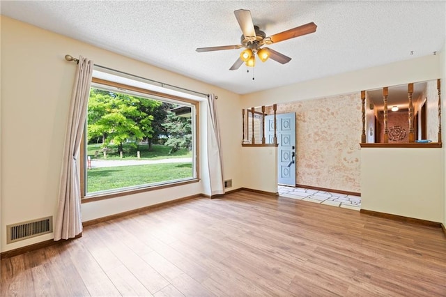 515 London Way, Belton, MO 64012 - spare room featuring baseboards, wood finished floors, a textured ceiling, and ceiling fan